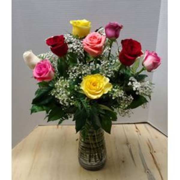 Mixed roses in a glass vase with baby's breath