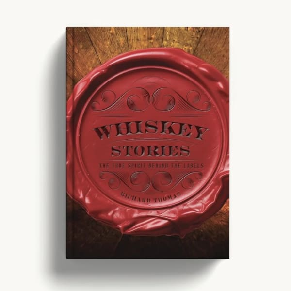 Red whiskey bottle cap on a wooden surface