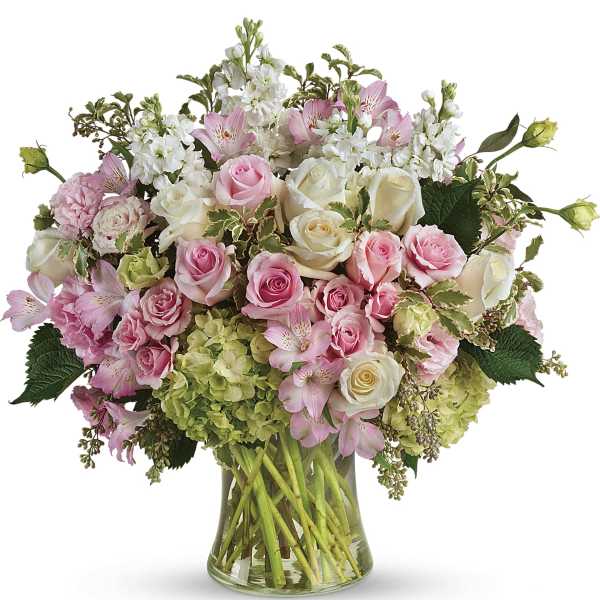 Pink and white roses with alstroemeria in a glass vase