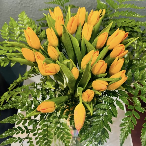 Orange tulip bouquet with fern foliage