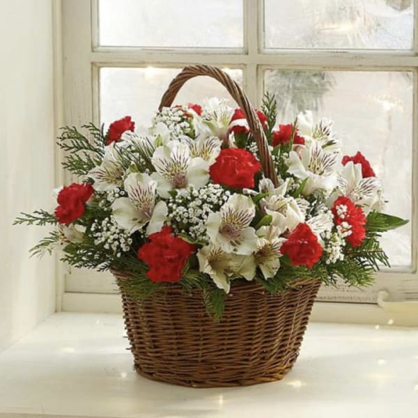 Basket of red and white flowers with a woven handle