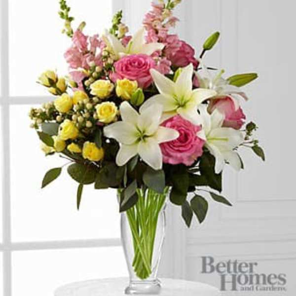 Pink and white floral bouquet in a clear glass vase