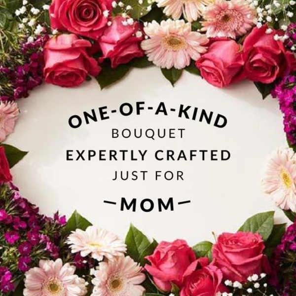 Pink roses and pale daisies arranged around a Mother's Day message