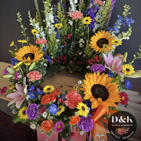 Large colorful floral wreath with sunflowers, lilies, and mixed blooms