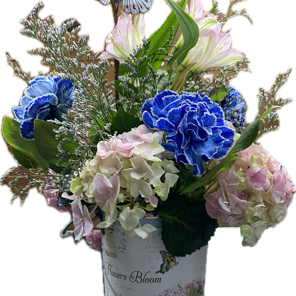 Blue and pink flowers in a decorative vase with a butterfly pick