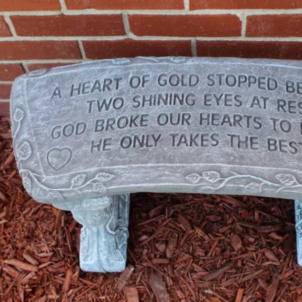 Gray memorial bench with an engraved sympathy poem