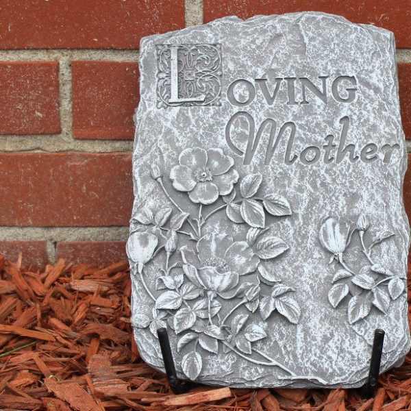 Decorative stone plaque reading "Loving Mother" with floral relief