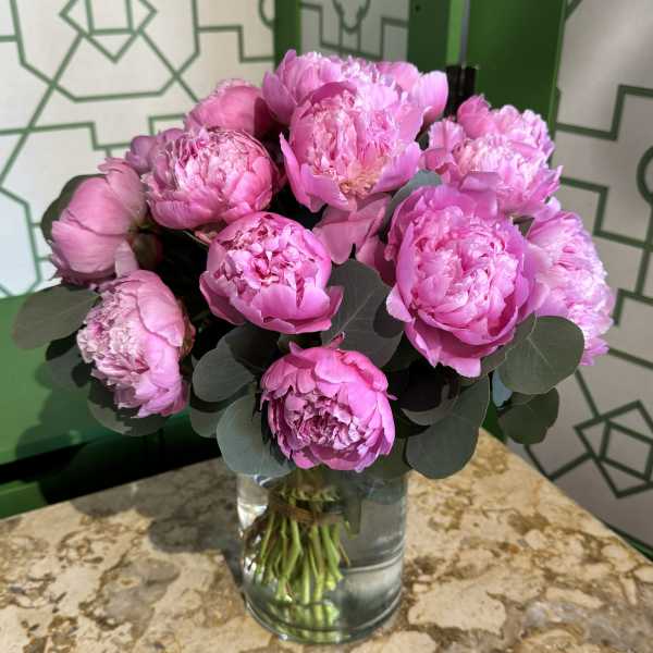 Pink peonies arranged in a clear glass vase