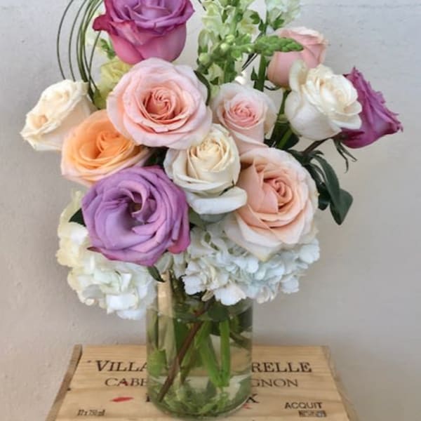 Bouquet of pastel roses in a clear glass vase