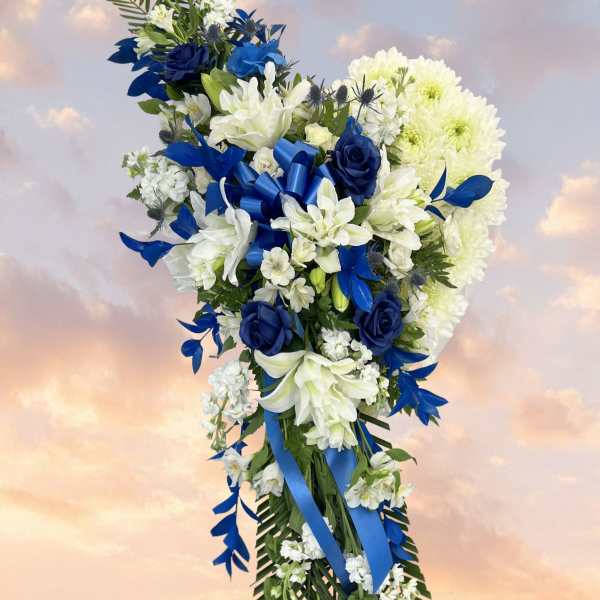 Blue and white floral standing spray with ribbon accents