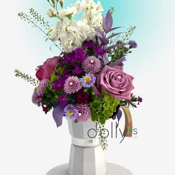 Purple and white mixed bouquet in a white vase