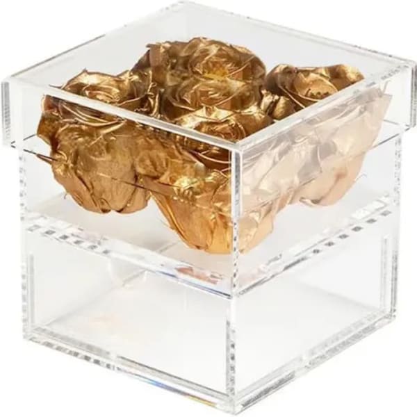 Clear acrylic box filled with gold foil rose shapes