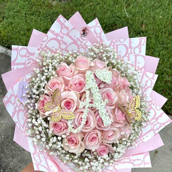Pink rose bouquet with baby's breath and butterfly decorations