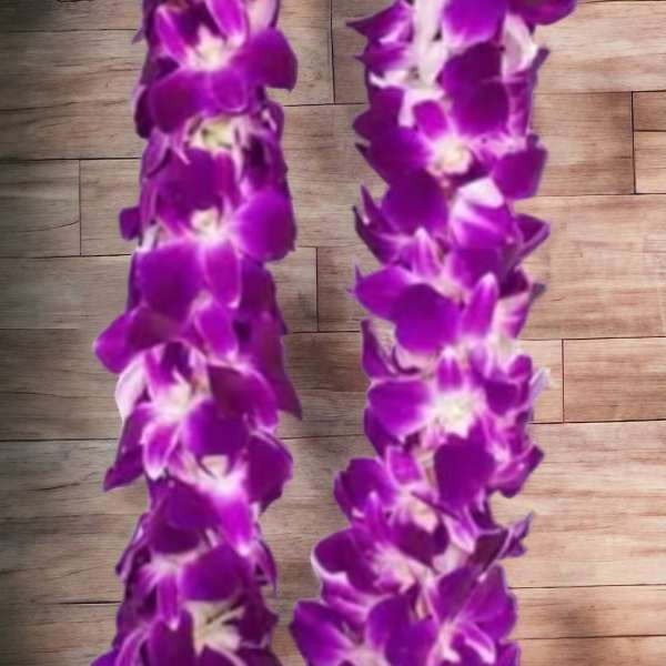 Purple orchid lei on a wood surface