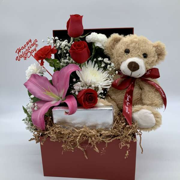 Gift box with red roses, pink lily, and teddy bear
