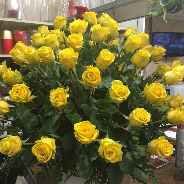 Large bouquet of yellow roses in a shop setting