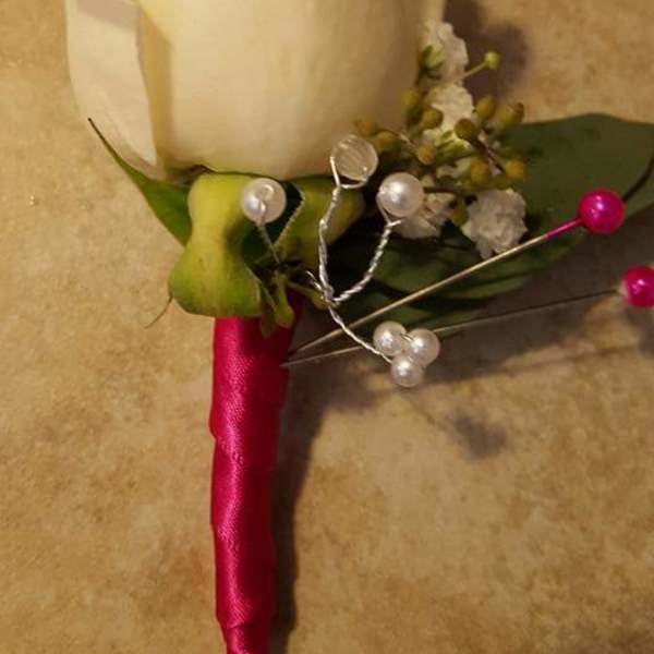 white and pink boutonniere