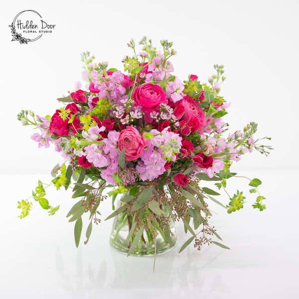 Pink and lavender mixed bouquet in a clear glass vase