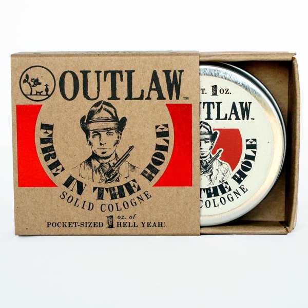 Outlaw Fire in the Hole solid cologne tin partially slid out of a brown cardboard box