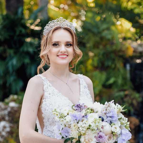 Bride holding a pastel bouquet and wearing a jeweled tiara