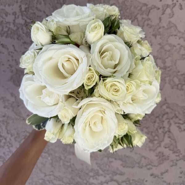 White rose bouquet held in hand