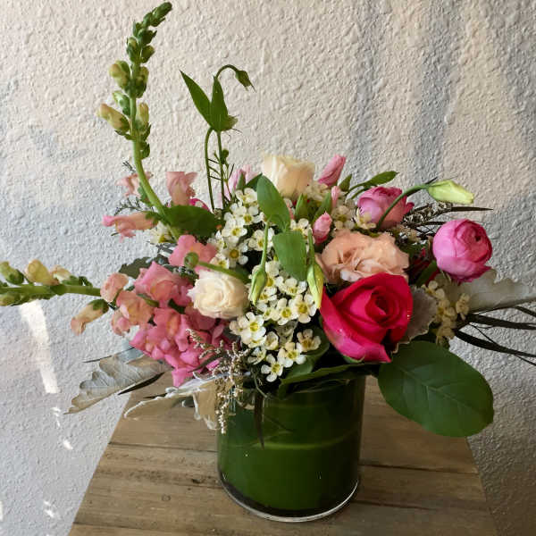 Pink and white mixed bouquet in a green vase
