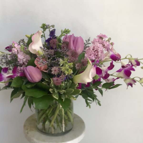 Pink and purple mixed bouquet in a clear glass vase