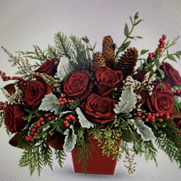 Red roses with pinecones and berries in a red container