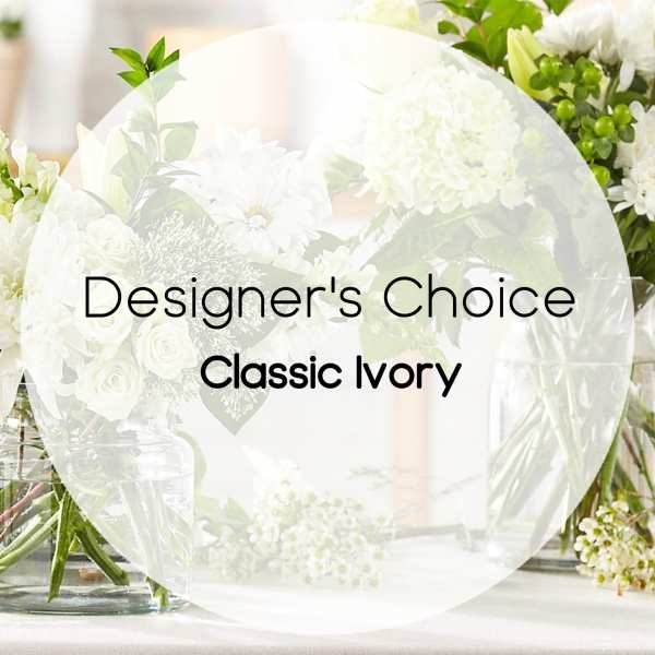 White floral arrangement with roses and daisies in glass vases
