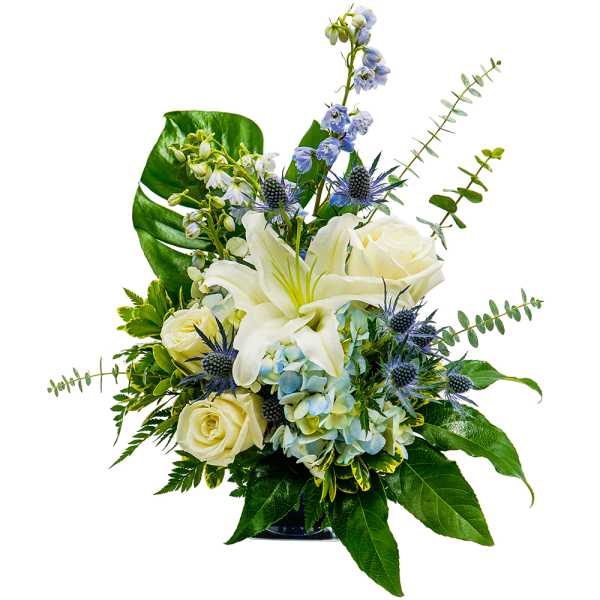 White lilies and roses with blue flowers in a glass vase