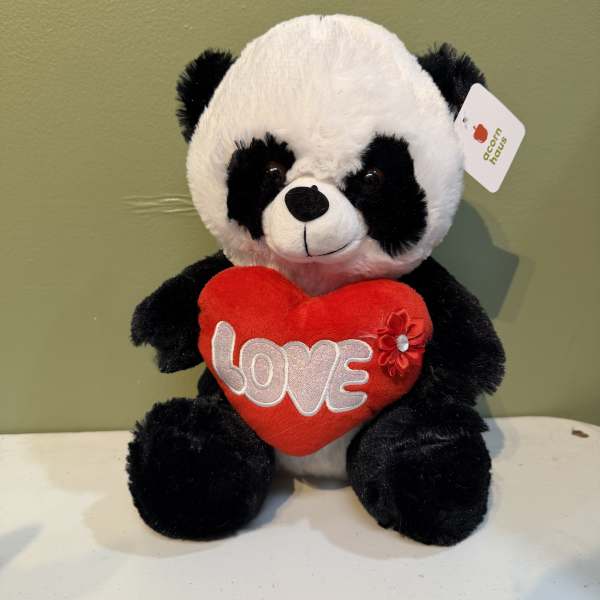 Plush panda holding a red heart with the word LOVE