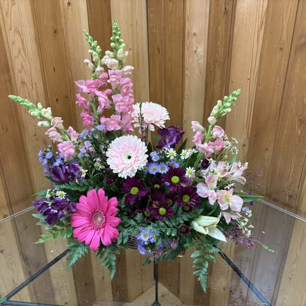 Mixed bouquet with pink gerbera daisies, snapdragons, and purple blooms