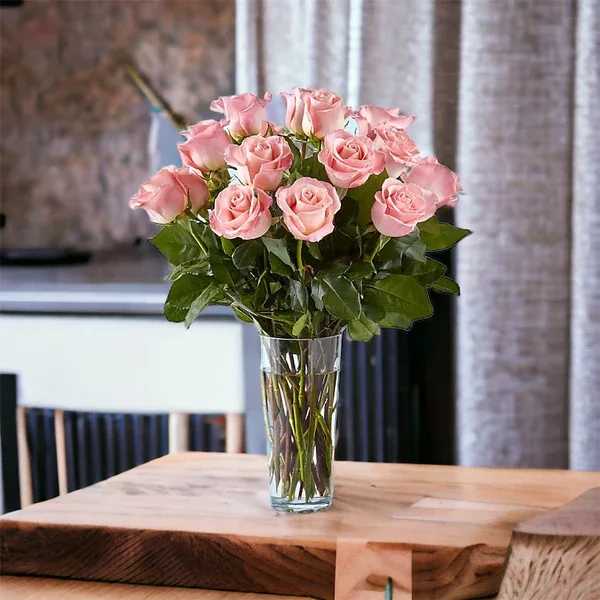 Pink roses arranged in a clear glass vase