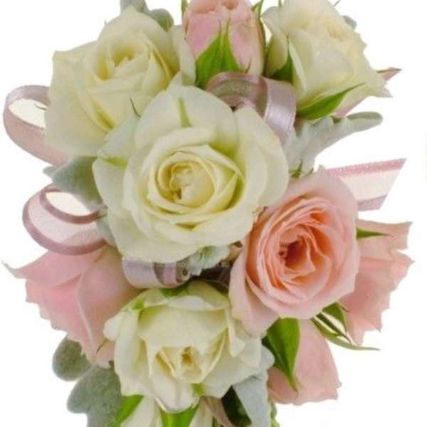 Bouquet of white and blush roses with pink ribbon accents