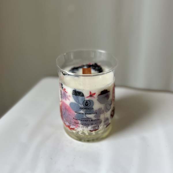Scented candle in a clear glass jar with a printed label