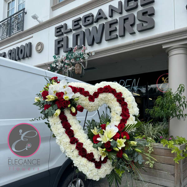 Heart-shaped floral standing spray with red roses and white blooms