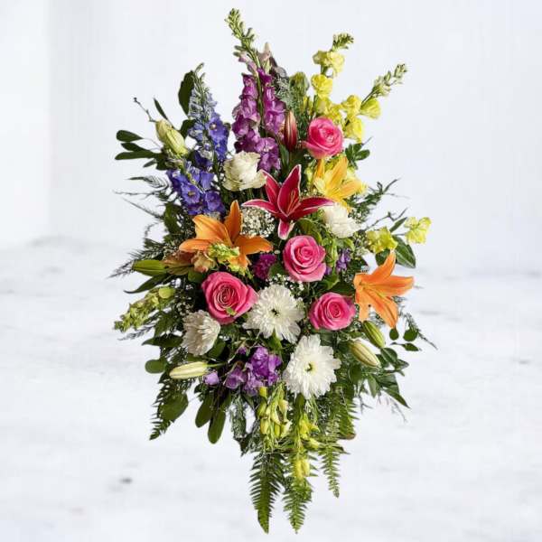 Tall mixed bouquet with pink roses, lilies, and purple flowers