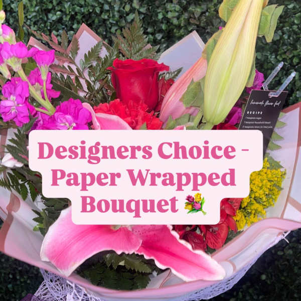 Paper-wrapped bouquet with pink and red flowers and a red rose