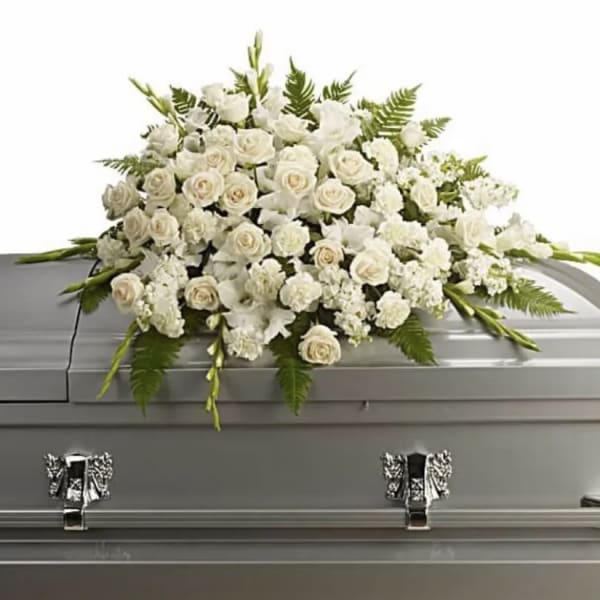 White floral spray on a silver casket