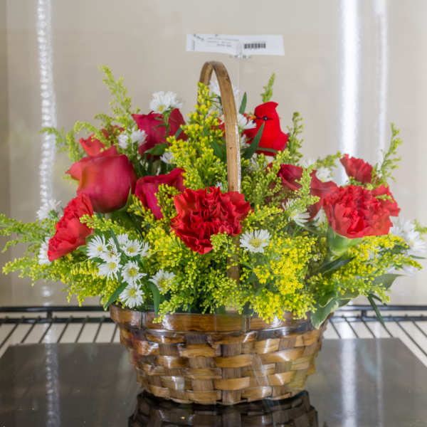 Basket arrangement of red carnations and roses with white daisies