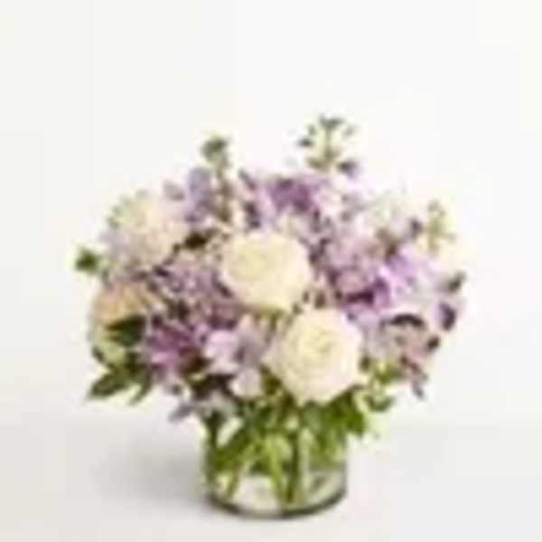 Lavender and white flower arrangement in a glass vase