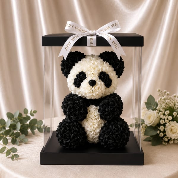 Black-and-white rose teddy bear in a clear display box with a ribbon
