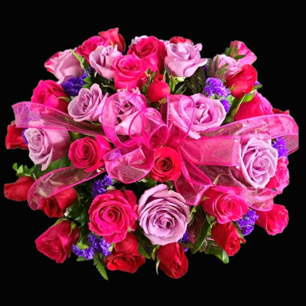 Bouquet of pink and red roses with a pink ribbon bow