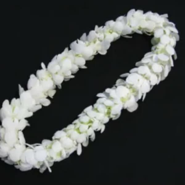 White flower lei on a black background