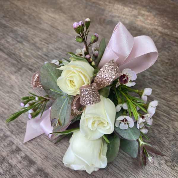 Small bouquet of white roses with pink ribbon and glitter bow