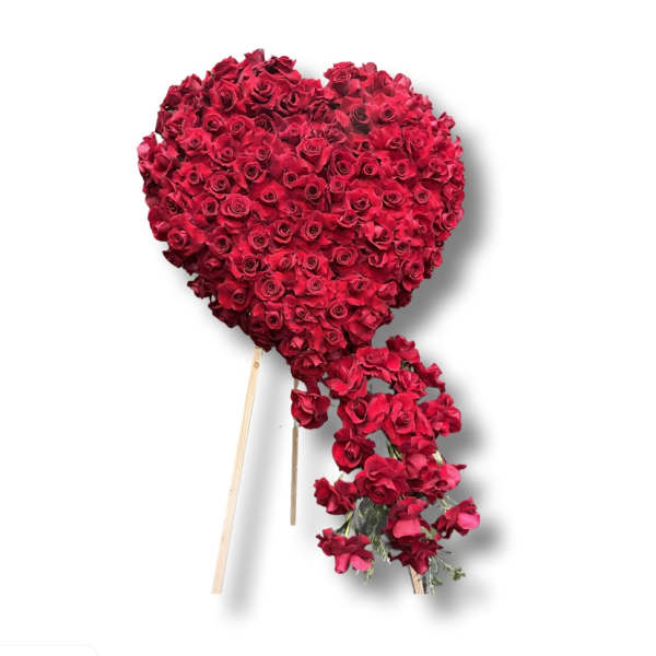 Heart-shaped red rose arrangement with a trailing cluster of roses