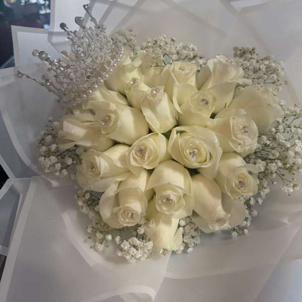 Cream rose bouquet with a silver tiara and white wrapping