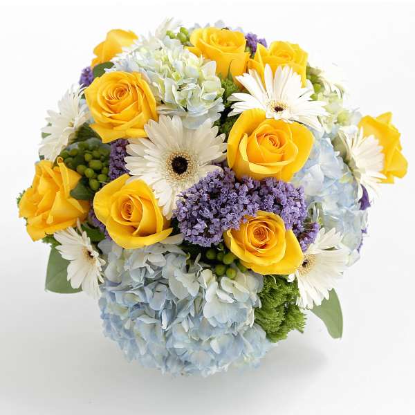 Bouquet of yellow roses, white daisies, and blue hydrangeas