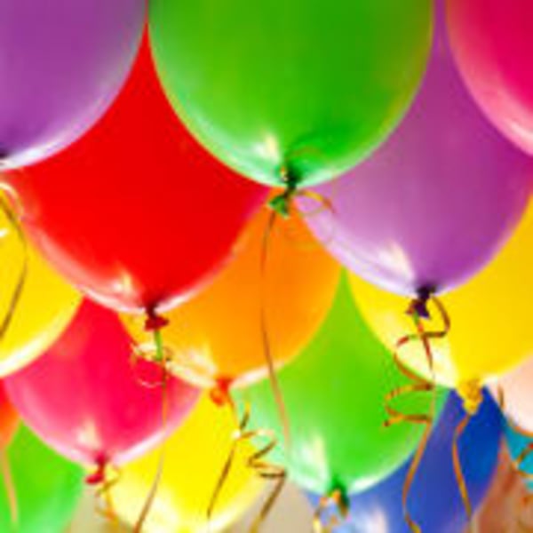 Colorful balloons with curled ribbons filling the frame