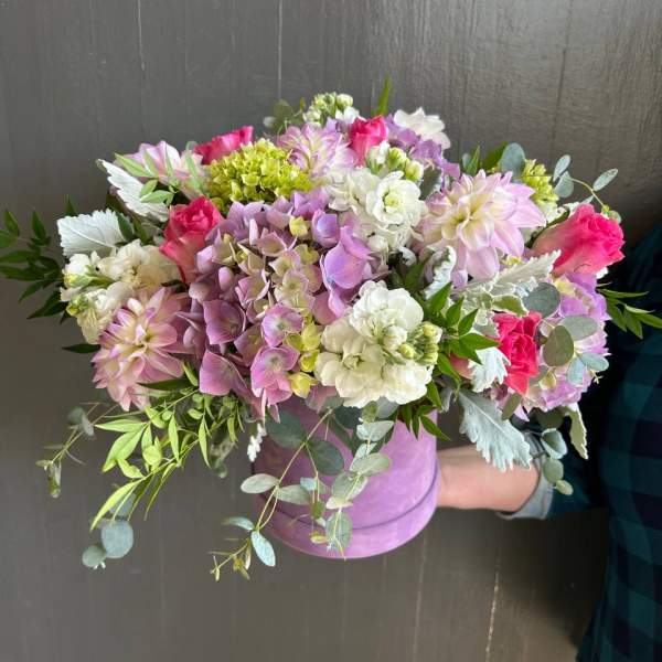 Mixed pink, white, and lavender bouquet in a lavender hat box